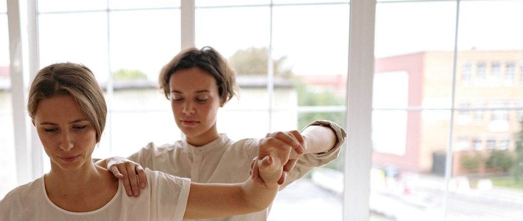 Physiotherapist guiding a patient through an exercise