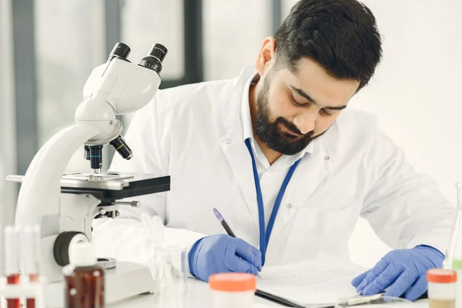 Laboratory professional working with a microscope